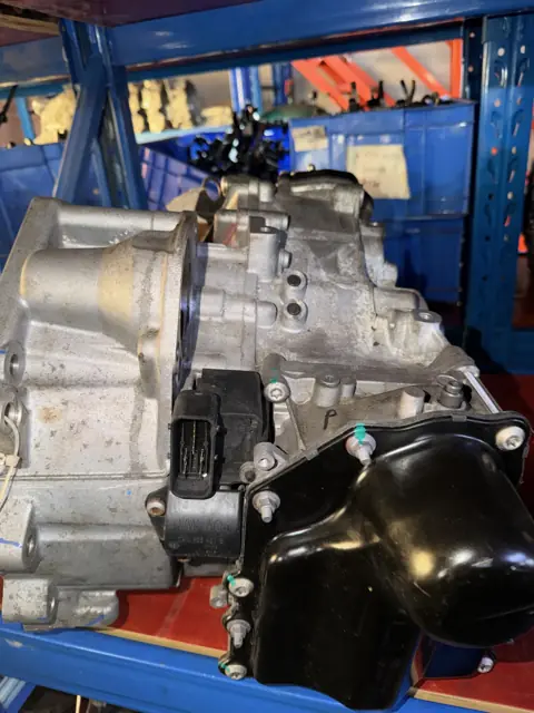 Transmission assembly on blue warehouse rack